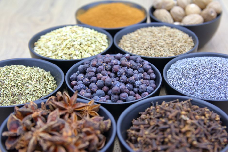 Assorted whole spices in bowls